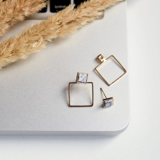 square earrings on the edge of the laptop